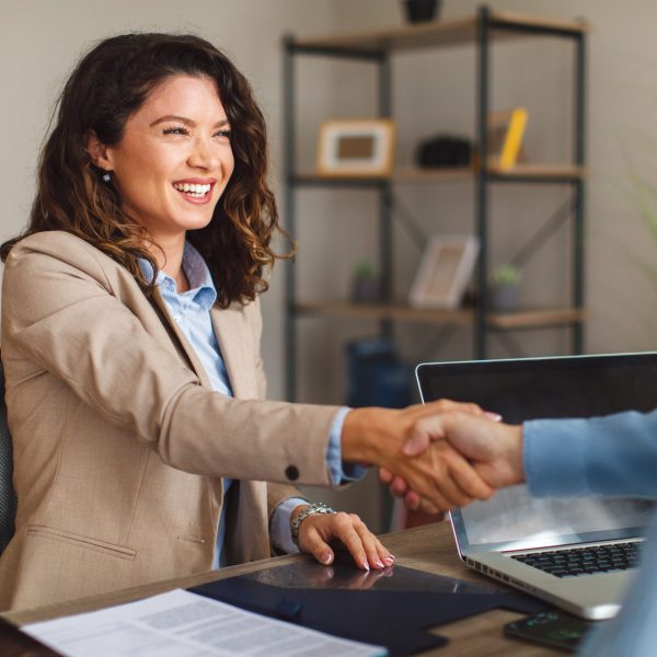 Young,Woman,Signing,Contracts,And,Handshake,With,A,Manager